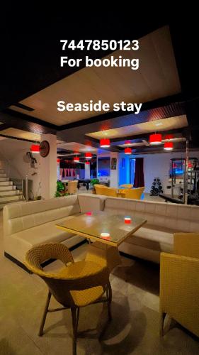 a room with a couch and a table and chairs at Seaside Stay in Arambol