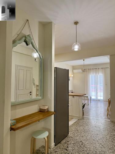 a kitchen with a stainless steel refrigerator and a table at Anefos apartment in Ágios Rókkos