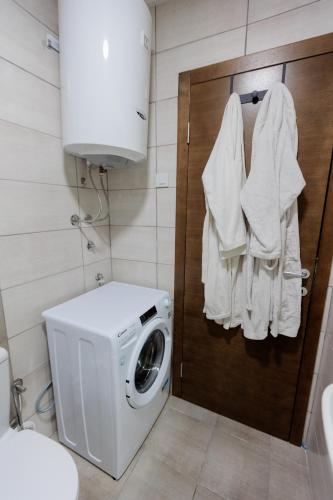 a washer and dryer in a bathroom with a washing machine at Harmonia Lux Aqua park in Jagodina