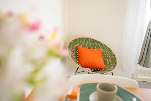 an orange pillow sitting on a chair in a room at Dal Don in Polignano a Mare
