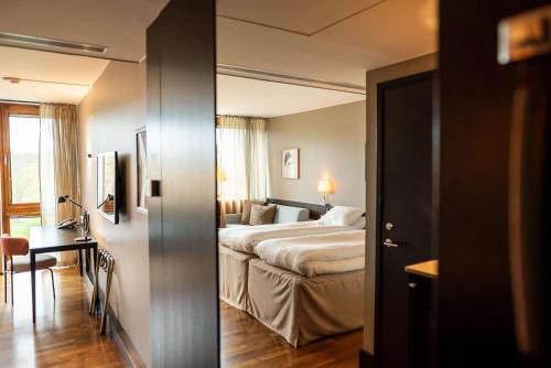 two pictures of a hotel room with a bed and a desk at Scandic Anglais in Stockholm