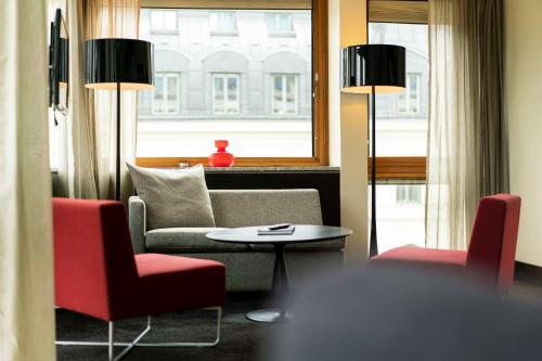 a living room with a couch and two chairs and a table at Scandic Anglais in Stockholm