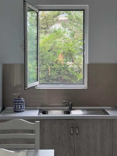 a kitchen with a sink and a window at Seahorse in Ksamil