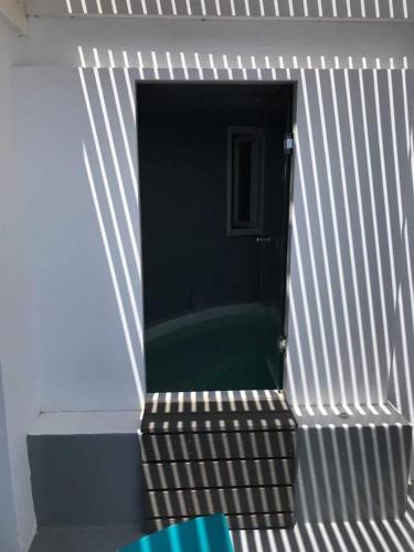 a stairway leading into a room with a green floor at Armeni Village in Oia