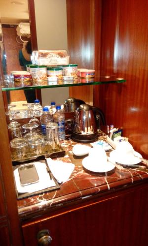 a kitchen counter with dishes and a tea kettle on it at Taj Krishna in Hyderabad