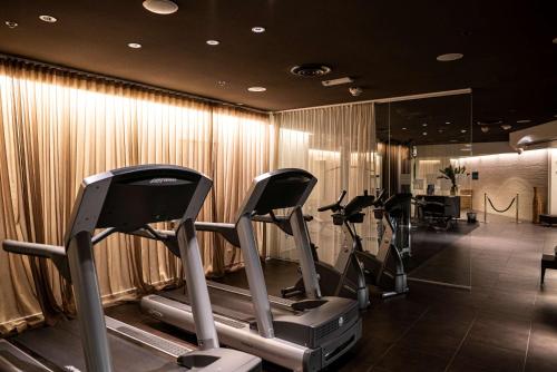 a gym with cardio equipment in a room at Scandic Anglais in Stockholm