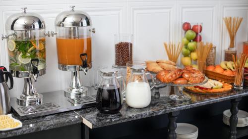 a counter with a bunch of food and milk at Cardinal in Quba