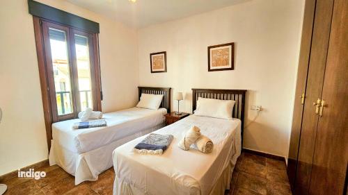 a room with two beds and a window at SIM01 Direct Access to Pool Area Las Lomas in Ayamonte