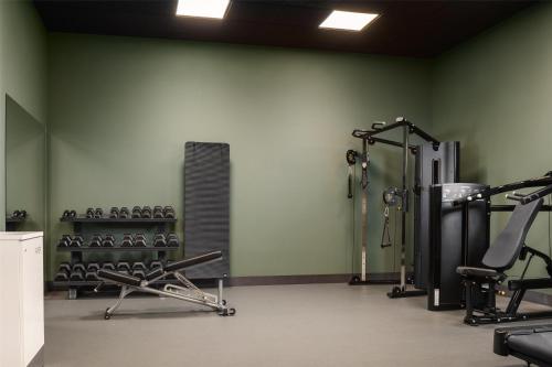 a gym with treadmills and machines in a room at Scandic Gardermoen in Gardermoen
