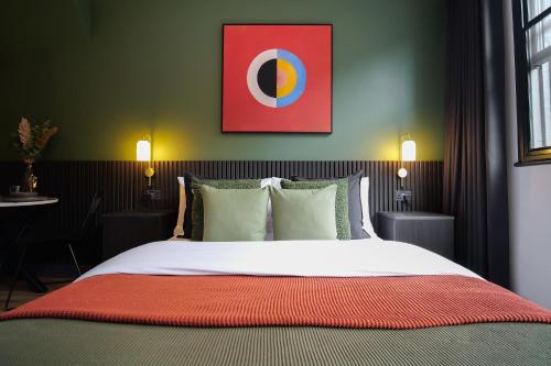 a bedroom with a large bed with a red blanket at Stylish Northern Quarter Studio, Ideal for Leisure & Work Stays in Manchester