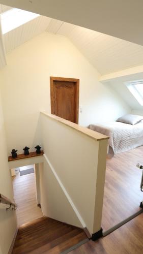 a attic room with two beds and a table at Gite de l'oseraie 