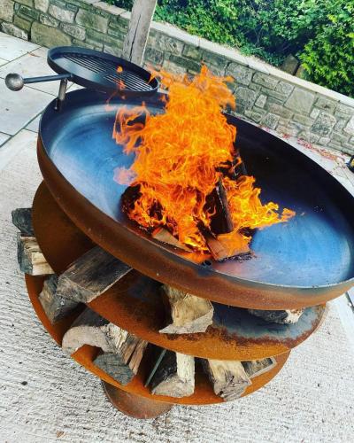 a fire in a pot on top of a grill at The Meadows Hut in Alvington