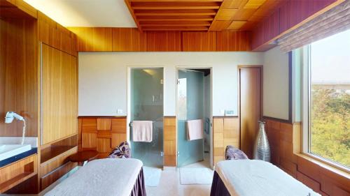 a bathroom with two beds and a sink at Radisson Blu Hotel, Nagpur in Nagpur