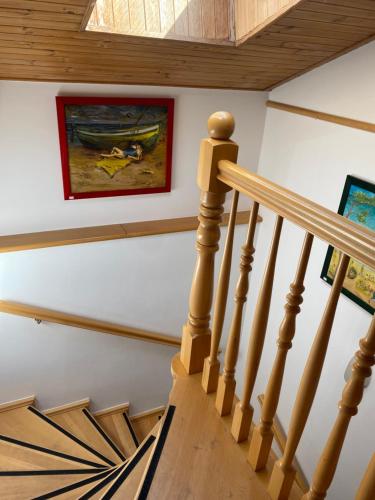 a stairway with a painting on the wall and a picture at Apartamenty Na Klifie Przystań 18 Chłapowo in Władysławowo