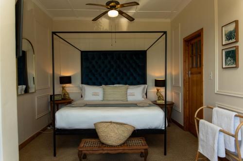a bedroom with a large bed and a ceiling fan at Sonnekus Boutique Hotel & Bistro in Kalk Bay