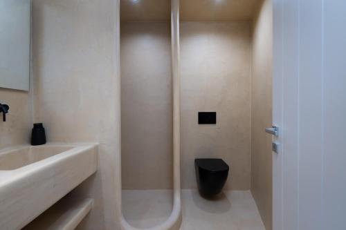 a bathroom with a shower and a sink and a toilet at White Orchid Boutique Apartments in Vóthon