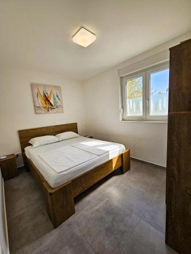 a bedroom with a large bed in a room at Apartman Sol Nin in Nin