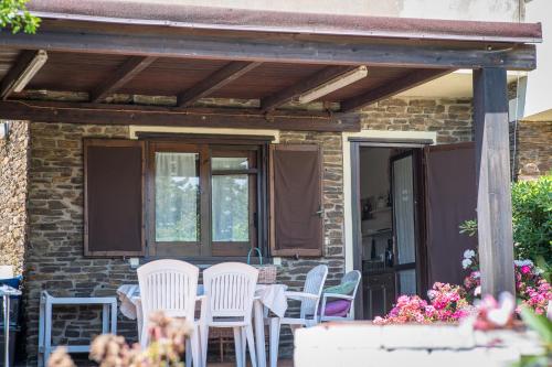 a patio with chairs and a table on a house at Casa Vacanze Sabina - Stintino in Stintino