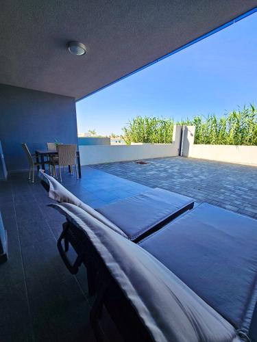 a room with two mattresses on top of a patio at Apartman Sol Nin in Nin