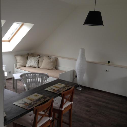 a living room with a table and a couch at Rezidence Věstonice in Horní Věstonice