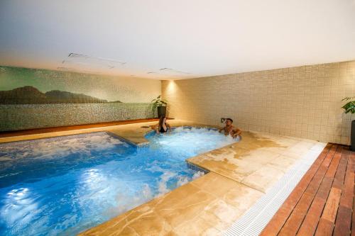 a swimming pool in a bathroom with blue water at Aparthotel Duva & Spa in Port de Pollensa