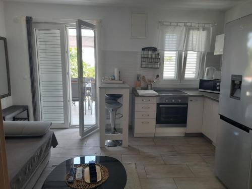 a kitchen with a couch and a table in a room at AnKaLo in Vir