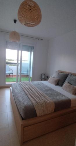 a bedroom with a large bed and a large window at Casa Émir in Roldán