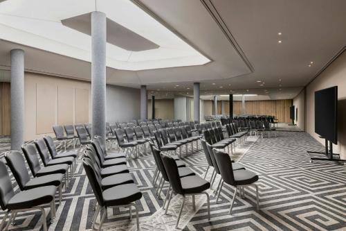 a conference room with chairs and a projection screen at JW Marriott Cannes in Cannes
