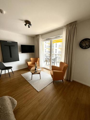 a living room with a couch and chairs and a table at Alp Art Hotel Monthey in Collombey