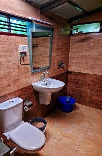 a bathroom with a toilet and a sink at Palathra Heritage in Mararikulam