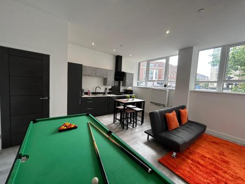 a living room with a pool table and a kitchen at Hull NEW Central Apartment 15 UNITS AVAILABLE in Hull
