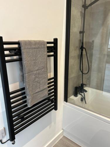 a bathroom with a towel on a rack next to a shower at Hull NEW Central Apartment 15 UNITS AVAILABLE in Hull