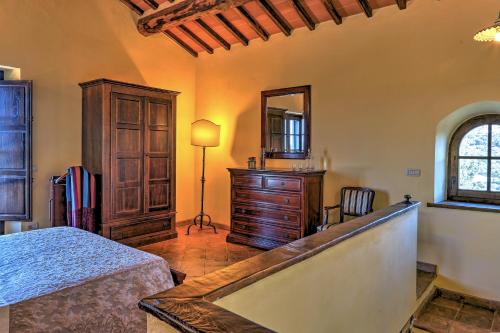 a bedroom with a bed and a dresser and a mirror at LE MACINE 6, Emma Villas in Castel del Piano
