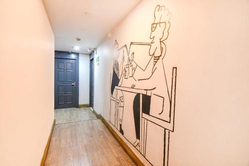 a hallway with a mural of a man in a mirror at FabHotel Suncitel - Nr Netaji Subhash Chandra Bose International Airport in Kolkata