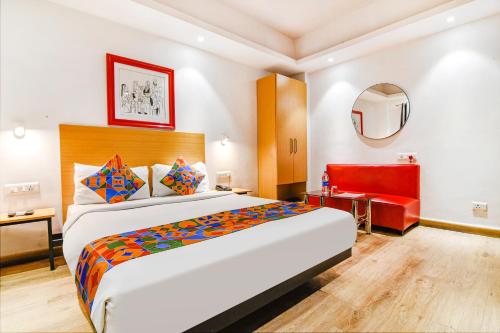 a hotel room with a large bed and a mirror at FabHotel Suncitel - Nr Netaji Subhash Chandra Bose International Airport in Kolkata