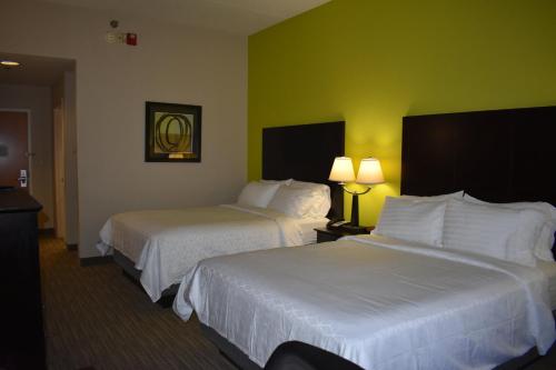 a hotel room with two beds and two lamps at Holiday Inn Express Apex - Raleigh by IHG in Apex