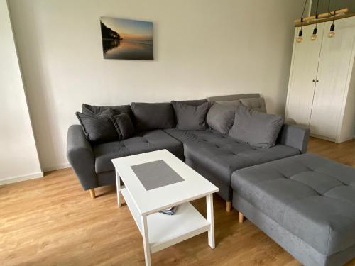 a living room with a couch and a table at Ferienwohnung Rehkitz in Drochtersen