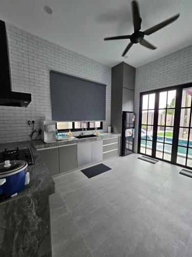 a kitchen with a ceiling fan in a room at Anjung ReNNai in Batu Caves