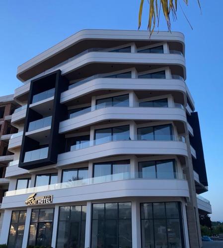a tall building with a sign on it at Hotel Adler in Ulcinj
