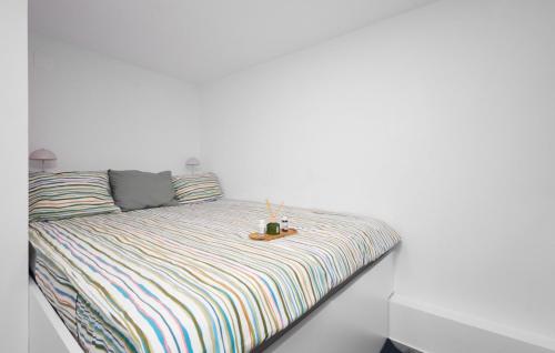 a bed in a room with a white wall at Villa Robinia Hill Residence by Villas Guide in Podbrđe