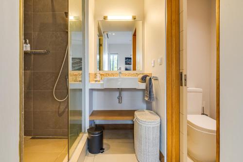 a bathroom with a sink and a shower at Cap Ouest by Horizon Holidays in Flic-en-Flac
