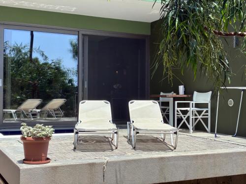 a group of chairs sitting on a patio at FinIQ Boutiq Studios in Foiníki