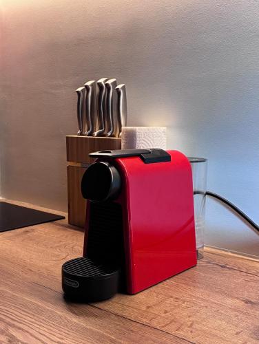 a red toaster sitting on top of a table at FinIQ Boutiq Studios in Foiníki