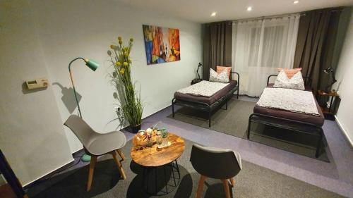a living room with two beds and a table at Gemütliche Ferienwohnung Berlin für 9 Personen in Berlin