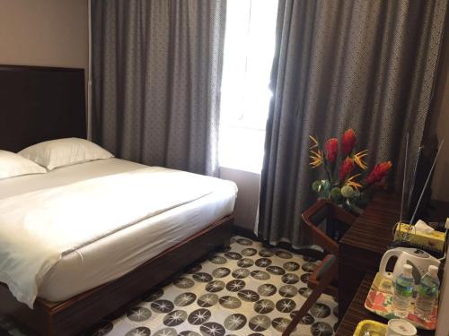 Ένα ή περισσότερα κρεβάτια σε δωμάτιο στο Fan Holiday Hotel