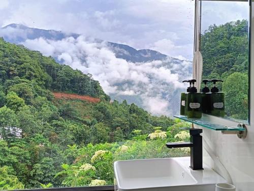 a bathroom sink with a view of a mountain at Cloud Garden in Bắc Yên