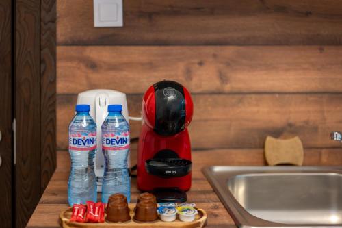 a coffee maker and two bottles of water on a counter at Martin's Treasure TOP CENTER in Sofia