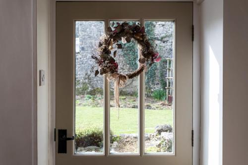 a wreath on the window of a door at Haverbrack Country House in Beetham