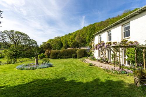 an exterior view of a house with a garden at Haverbrack Country House in Beetham