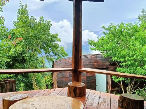 an umbrella sitting on top of a wooden table at Cloud Garden in Bắc Yên